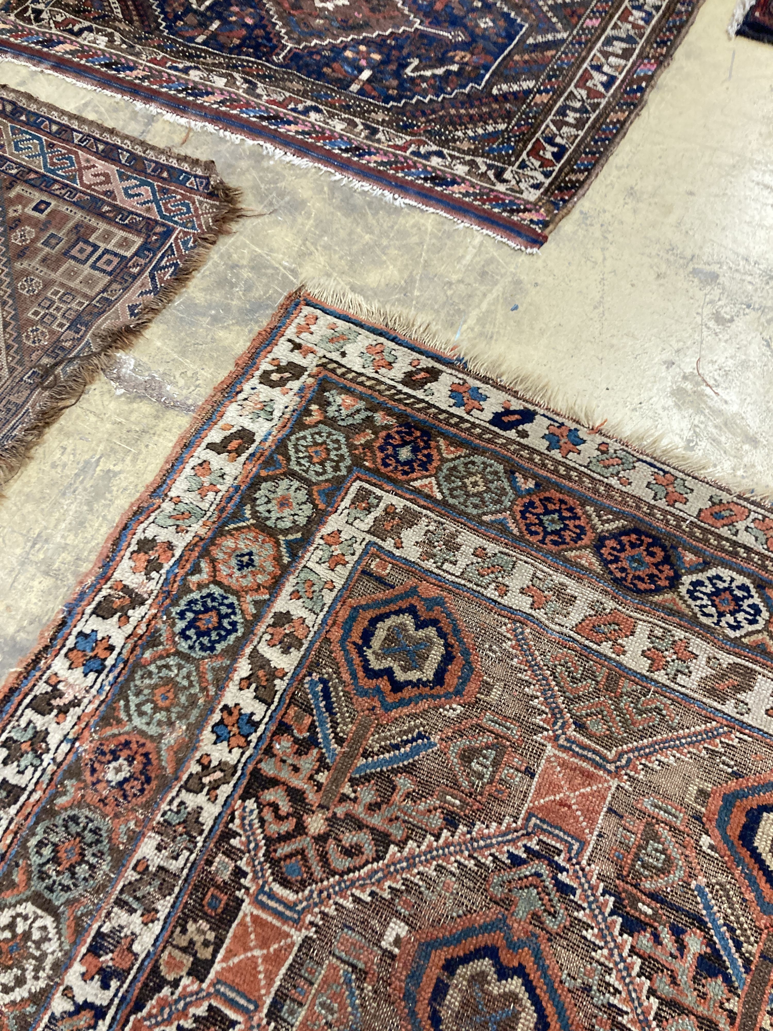 An antique Caucasian red ground rug, 250 x 125 cm and a smaller Shiraz rug.